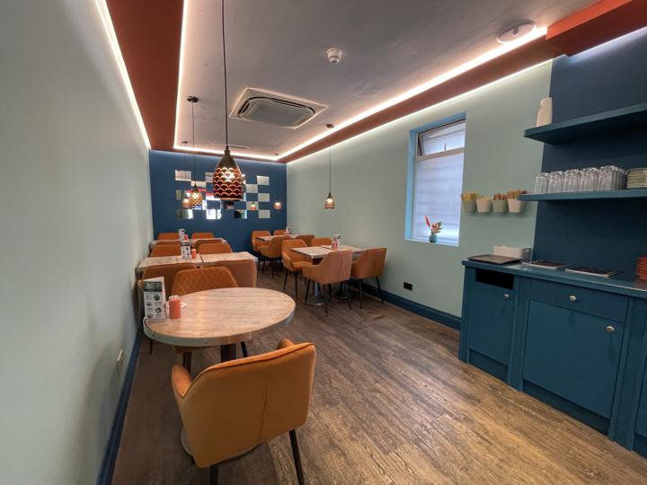Café dining room in sage and deep blue with coloured ceiling bands