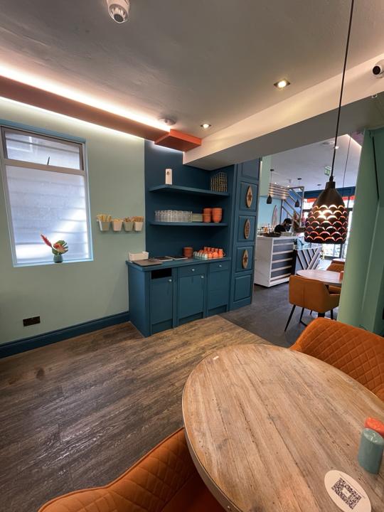 Painted teal cabinetry and shelving